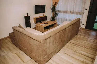 a large couch in a living room with a television at Vikendica Buzadzija M&N