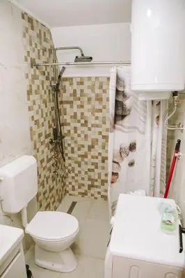 a bathroom with a toilet and a sink and a shower at Vikendica Buzadzija M&N