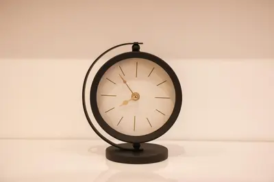 a black clock sitting on top of a table at Apartman Nikola in Livno