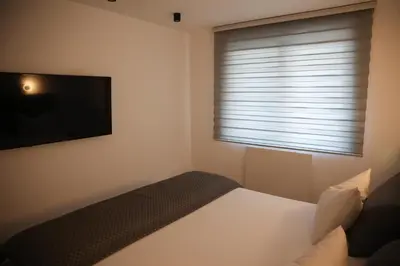 a bedroom with a bed and a flat screen tv at Apartman Nikola in Livno