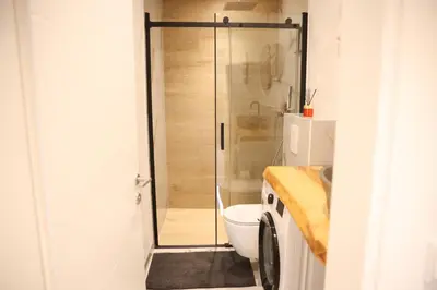 a bathroom with a toilet and a glass shower at Apartman Nikola in Livno