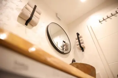 a bathroom with a mirror and a sink at Apartman Nikola in Livno