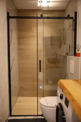 a bathroom with a shower with a toilet and a sink at Apartman Nikola in Livno