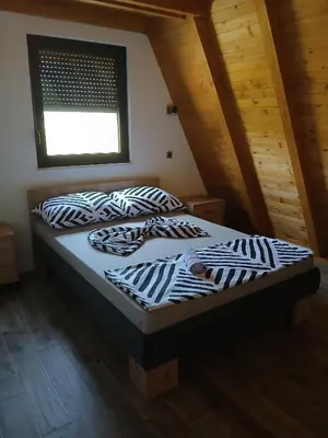 a bed with black and white pillows in a room at Villa Rustic