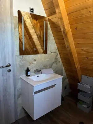 a bathroom with a sink and a wooden ceiling at Villa Rustic