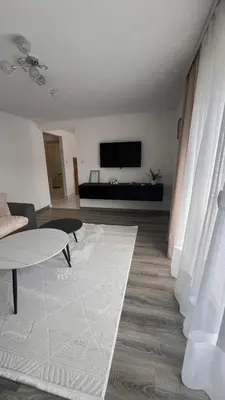 a living room with a couch and a tv at White house Paradise in Bihać