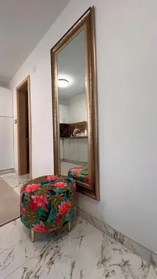 a mirror on a wall with a chair in front of it at White house Paradise in Bihać
