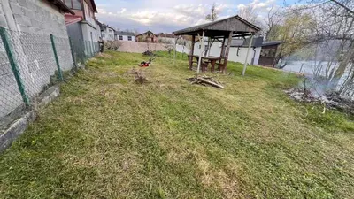a yard with a gazebo in the grass at White house Paradise in Bihać