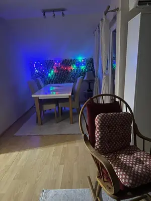 a dining room with a table and chairs and lights at Stan Travnik in Travnik