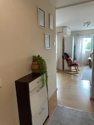 a living room with a dresser with a plant on it at Stan Travnik in Travnik