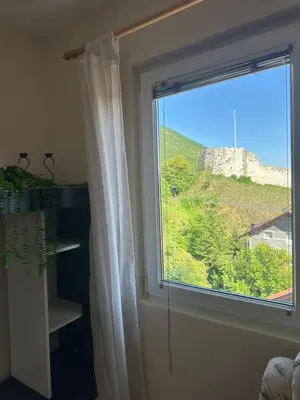 a window with a view of a castle at Stan Travnik in Travnik