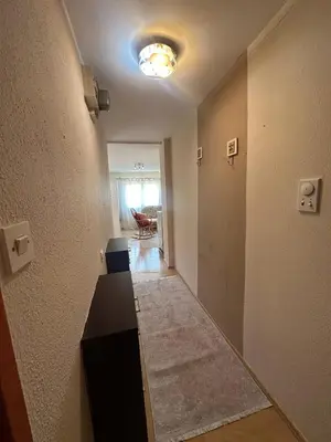 an empty hallway with a table and a light at Stan Travnik in Travnik