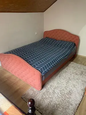 a bed in a room with a blue mattress at Stan Travnik in Travnik