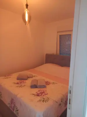 a bedroom with two beds and a window at Apartman Jana 2 in Doboj