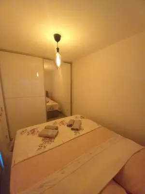 a small bedroom with a bed with two books on it at Apartman Jana 2 in Doboj