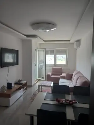 a living room with a couch and a table at Apartman Jana 2 in Doboj
