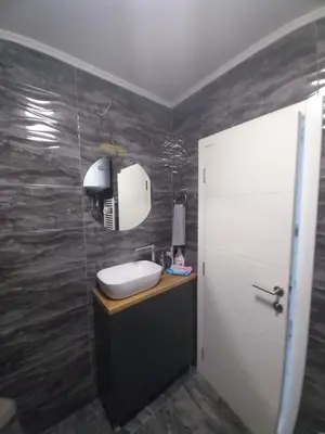 a bathroom with a sink and a mirror at Apartman Jana 2 in Doboj