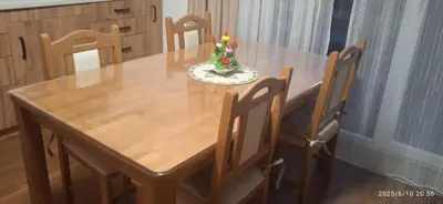 a wooden table with a vase of flowers on it at Apartman ANNA in Jajce