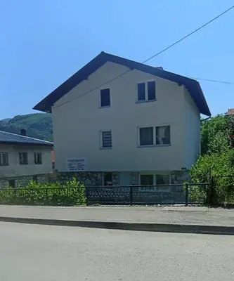 a large white house on the side of a street at Apartman ANNA in Jajce