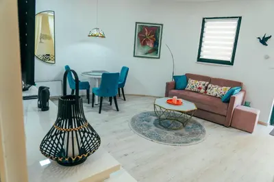 a living room with a couch and a table at Apartman Suada in Fojnica