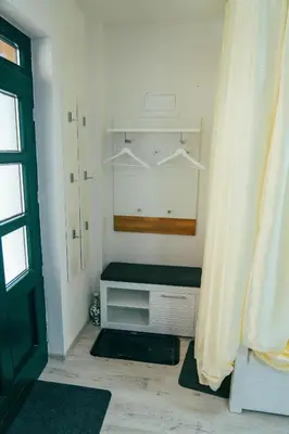 a room with a closet with a mirror and a door at Apartman Suada in Fojnica