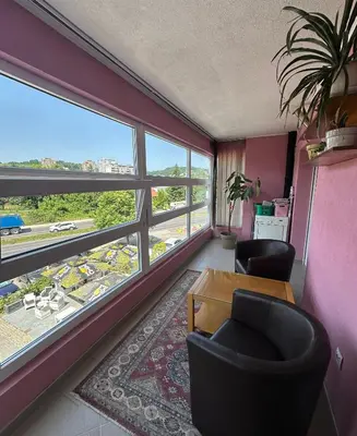 a room with two chairs and a table and a large window at Apartment Bella - Tuzla, Mejdan in Tuzla