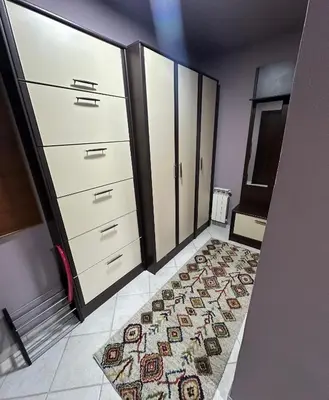 a room with white cabinets and a rug on the floor at Apartment Bella - Tuzla, Mejdan in Tuzla