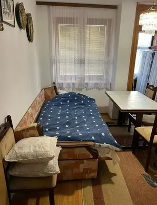 a room with a bed and a table and a window at Royal Travnik in Travnik