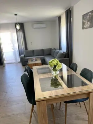 a living room with a table and a couch at Apartman David in Jajce