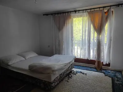 a bed sitting in a room with a window at Apartman Džanan in Jajce