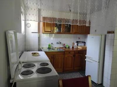 a kitchen with a stove and a white refrigerator at Apartman Džanan in Jajce