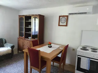 a kitchen with a dining room table and a stove at Apartman Džanan in Jajce