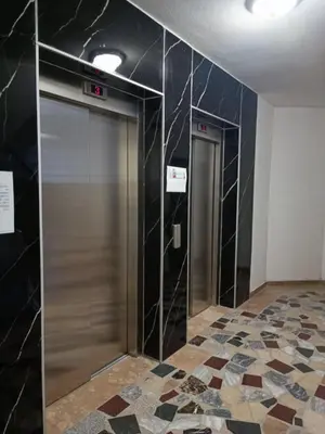 two elevators in a room with a tile floor at TriM Apartments in Travnik