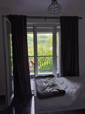 a bedroom with a bed in front of a window at TriM Apartments in Travnik
