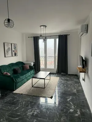 a living room with a green couch and a table at TriM Apartments in Travnik