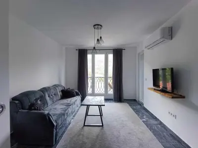 a living room with a couch and a tv at TriM Apartments in Travnik