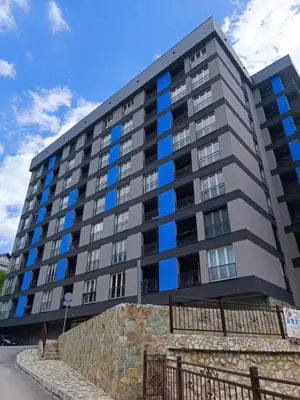 a large apartment building with blue windows at TriM Apartments in Travnik