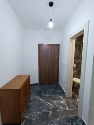 a room with a wooden door and marble floor at TriM Apartments in Travnik