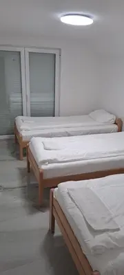 a row of three beds in a room at Apartman Aydan in Jajce