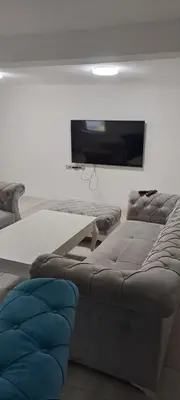 a living room with a couch and a flat screen tv at Apartman Aydan in Jajce