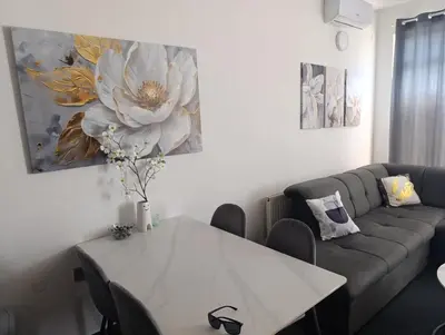 a living room with a white table and a couch at Relax 2 in Bosanska Dubica
