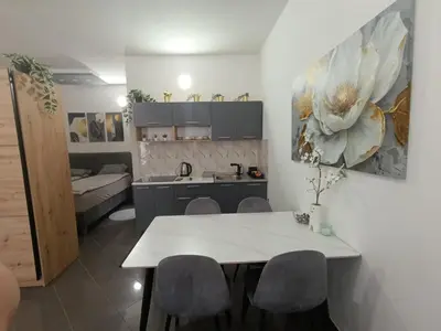 a kitchen and living room with a table and chairs at Relax 2 in Bosanska Dubica