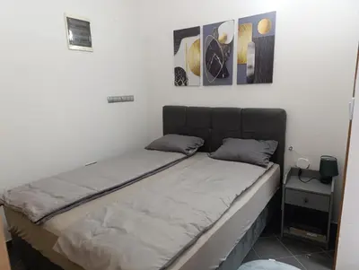 a bed in a room with three pictures on the wall at Relax 2 in Bosanska Dubica