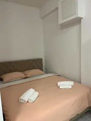 a bed with two white towels on top of it at SM studio apartman in Banja Luka