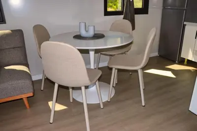 a dining room table with four chairs and a table at Rama holiday resort in Prozor