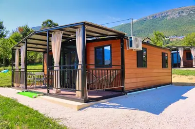 a tiny house with a porch and a deck at Rama holiday resort in Prozor
