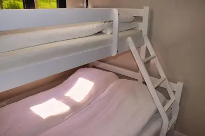a bunk bed with a ladder in a room at Rama holiday resort in Prozor