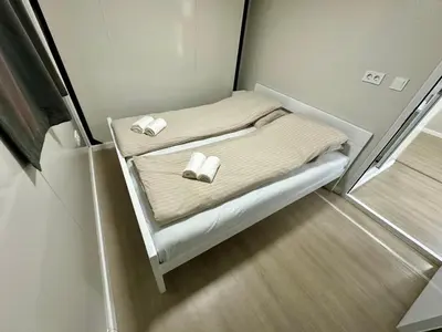 a small bed in a small room with towels on it at Rama holiday resort in Prozor