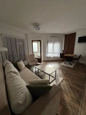 a living room with a couch and a table at Apartman Palazzo in Bosanska Krupa