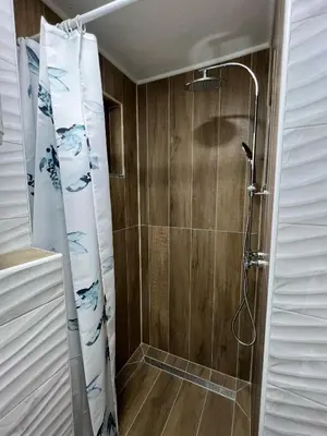 a shower with a shower curtain in a bathroom at Apartman Palazzo in Bosanska Krupa
